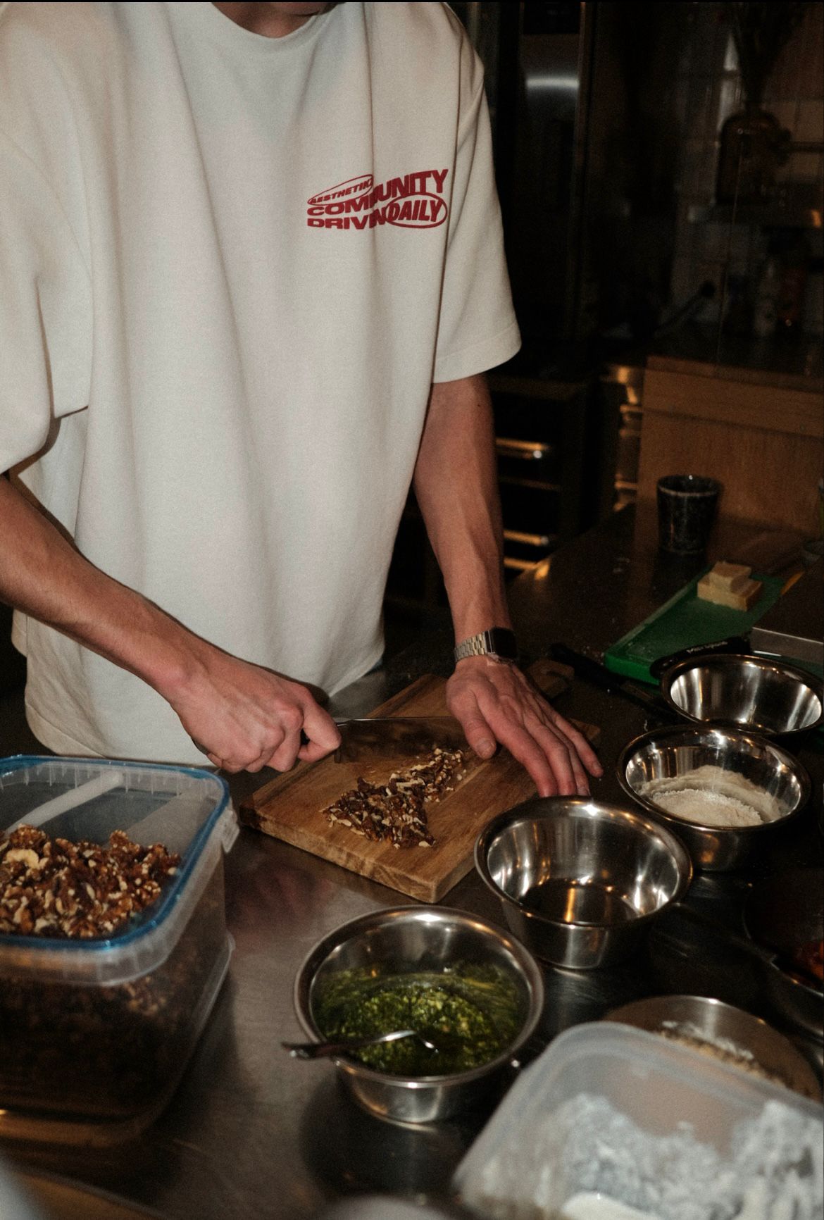 A guy cutting on a cutting board with a knife
